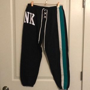 Pink Sweatpants in Black with White and Teal Stripe down the leg.